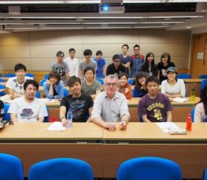 Professor Mike Walsh with students in Hong Kong. 