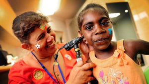 Sandy Nelson as she checks the ear of Kirsty Dumoo during the opening of the Wadeye Health Centre, Nov. 9, 2010. Photo: Clive Hyde, PR Handout