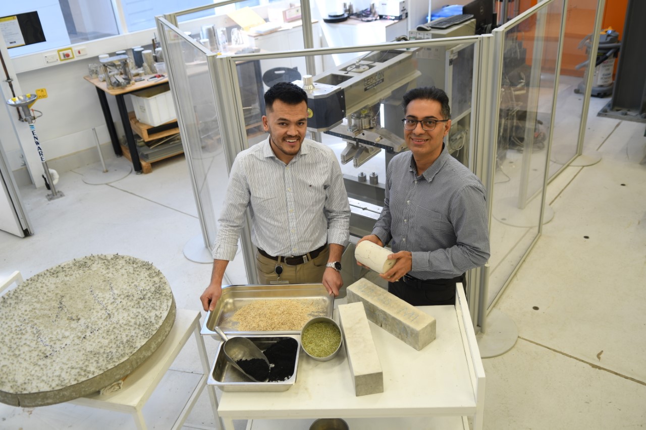 Flinders University sustainable construction materials lead researcher Dr Aliakbar Gholampour, right, and PhD civil engineering candidate Zakir Ikhasi who use natural fibres, lead slag (black sand) and waste glass sand materials in new-age concrete mixes