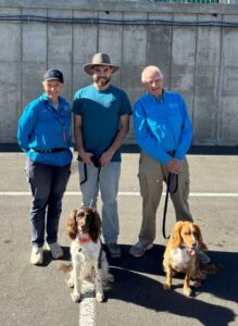 Mandy Jones from Conservation Dogs SA, left, and Sebastian Rea, from the Flinders Lab of Evolutionary Genetics and Sociality (LEGS) with Nessie and Badger, led by Graham Dodd, also from Conservation and Detection Dogs SA.